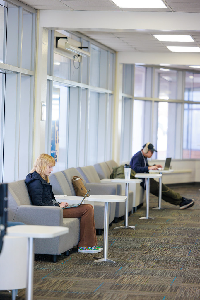 High school students studying at library tables while preparing for the ACT and SAT.